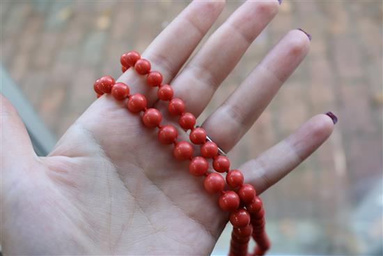 A single strand graduated coral bead necklace, with yellow metal clasp, gross weight 53 grams, 64cm.